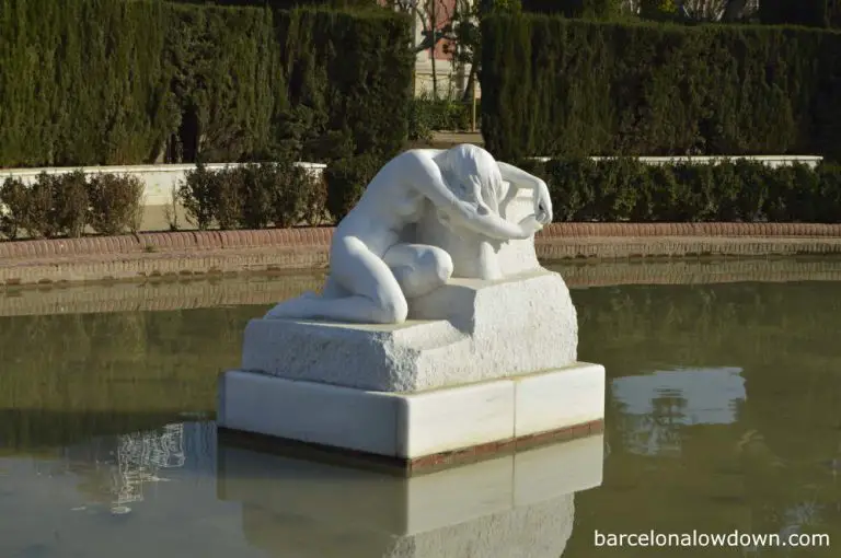 Desolation - A white marble statue of a weeping woman in a pond