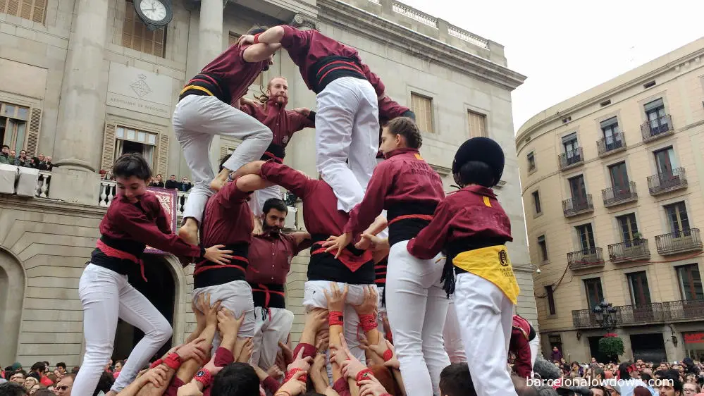 A group of Castellers building a human tower in front of Barcelona Town Hall