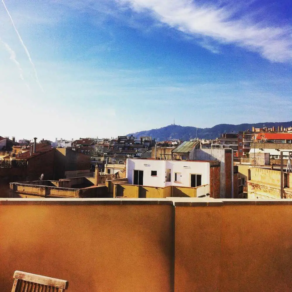 Looking out over the rooftops in Barcelona with the Collserola mountain range in the background