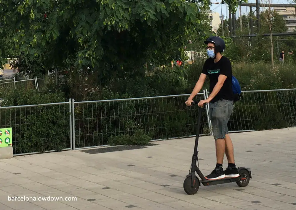 Riding an electric scooter in a park in Barcelona, Spain