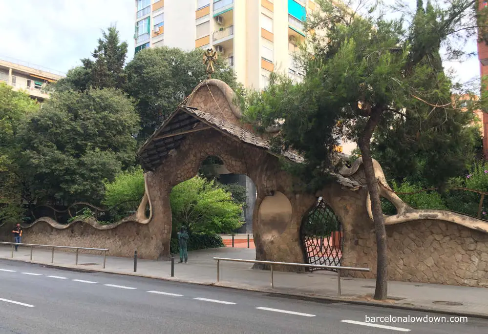 The lobed modernist gateway and stone walls that once surrounded the Miralles estate in Barcelona, Spain