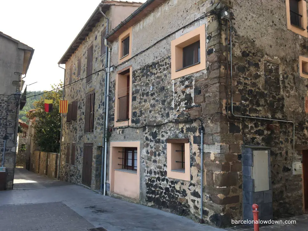Narrow streets and buildings made of volcanic rock in Castellfollit de la Roca, Spain