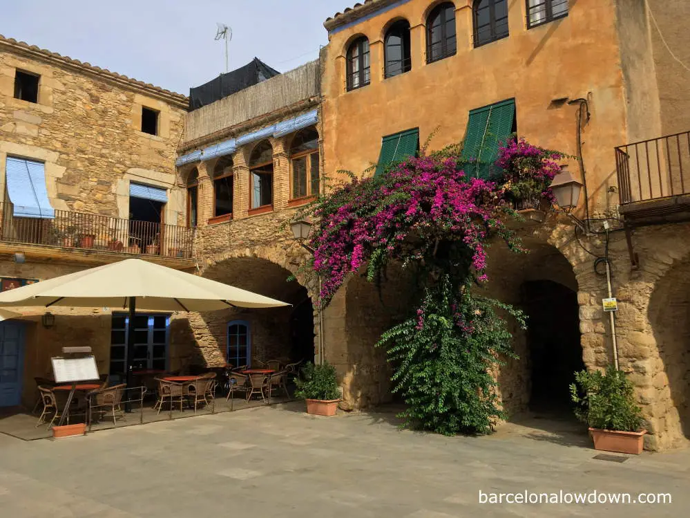 A picturesque square with stone arches in Peratallada on the Spanish Costa Brava