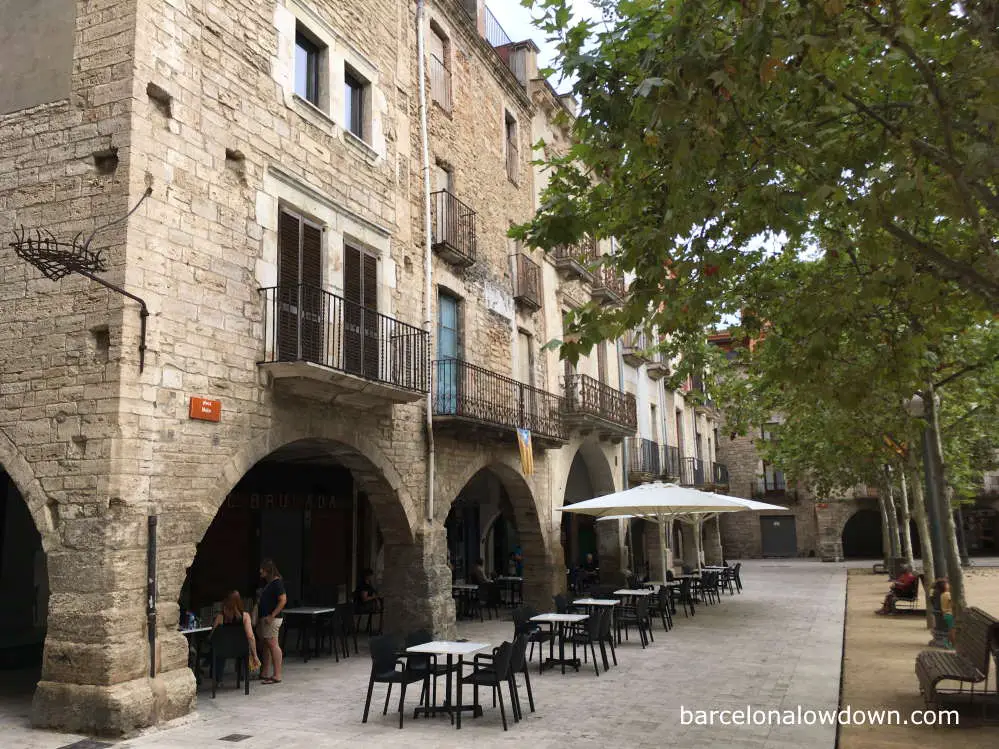 Arcaded medieval buildings surrounding the main plaza of Banyoles