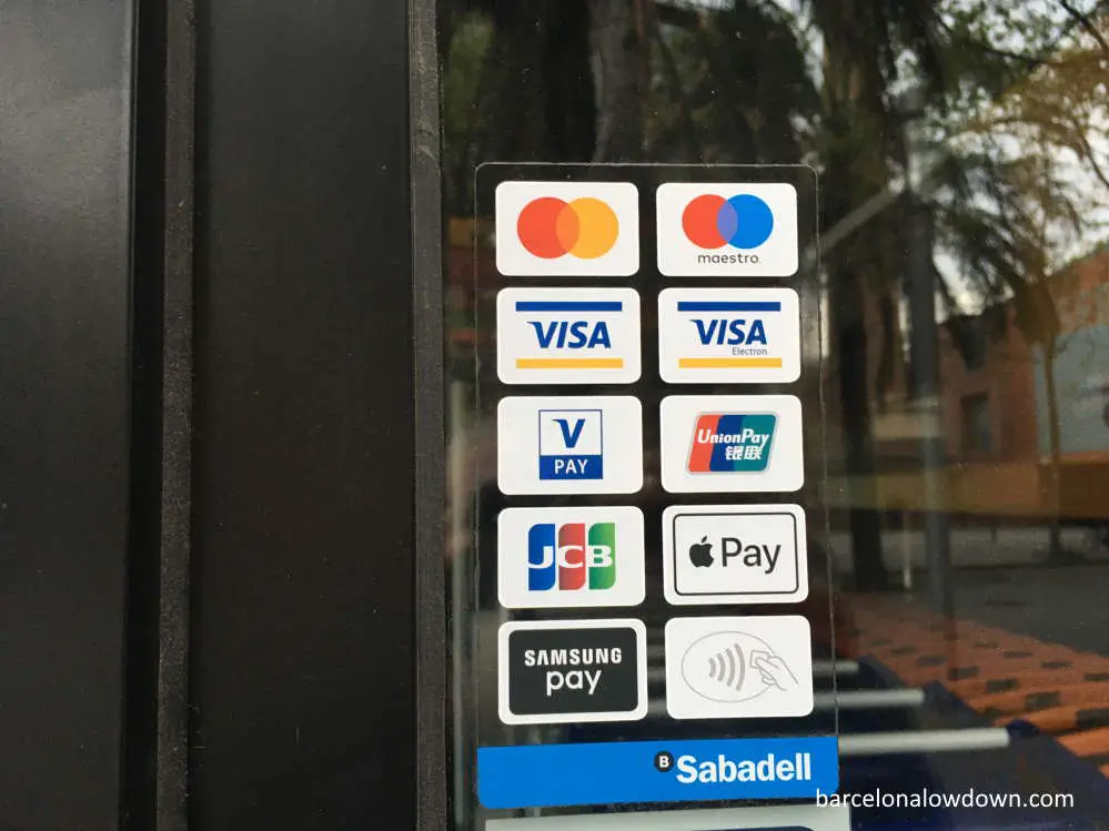 Sticker in a shop doorway in Barcelona showing which payment methods are accepted including contactless payments, Apple Pay and Google Pay