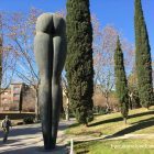 A man walking past the seven metre high arse monument in Barcelona