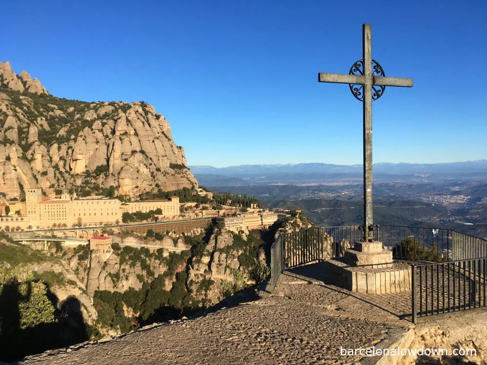 View of Montserrat with St Michael's Cross in the foreground and the Pyrenees Mountains in the background