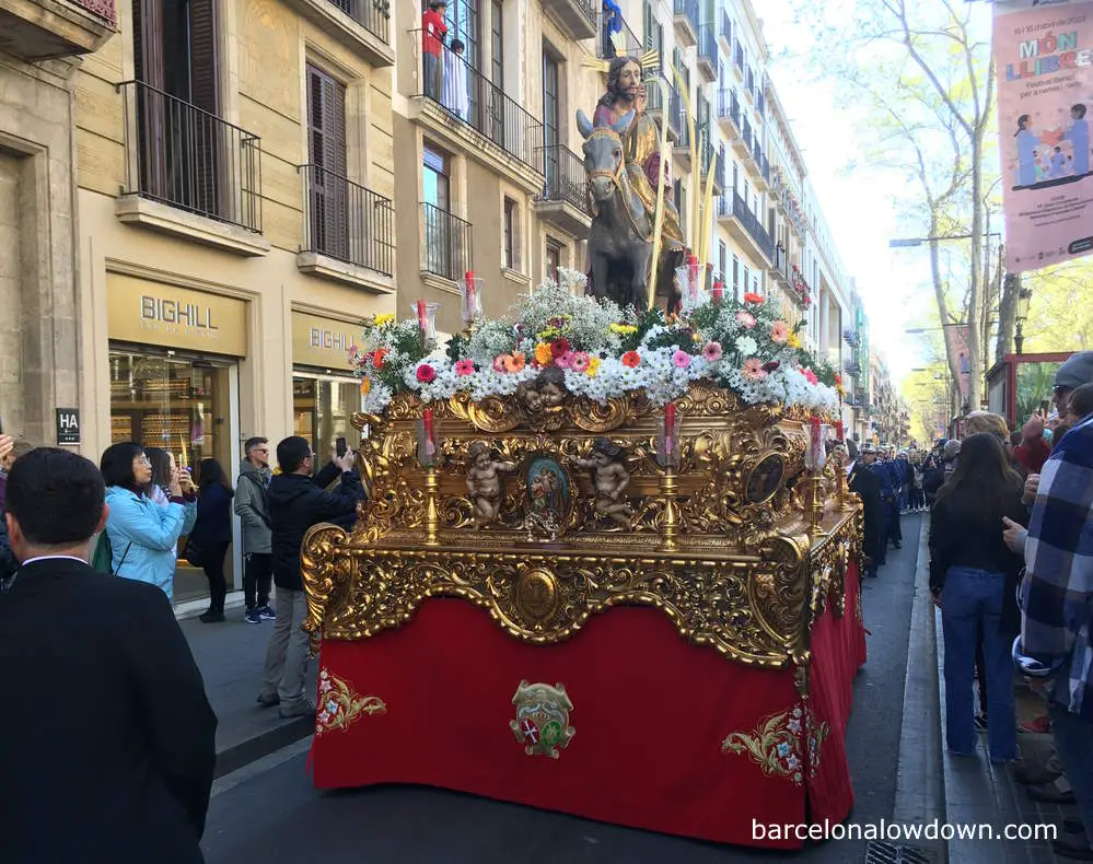 Jesus on a donkey being paraded through the streets of Barcelona on Palm Sunday