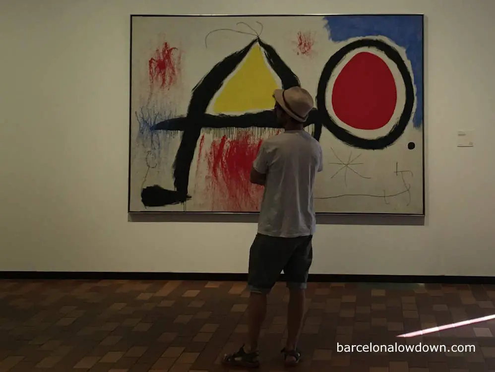 A man looking at a painting in the Fundació Joan Miró art museum, Barcelona