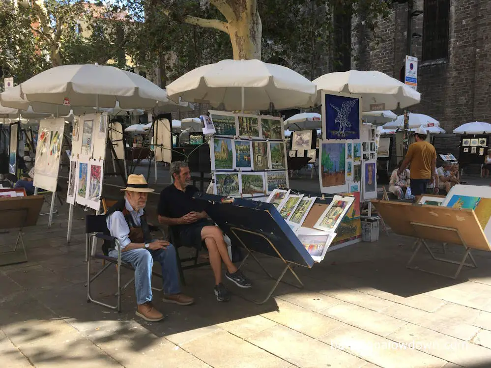 An open air artists market in front of a church in Barcelona