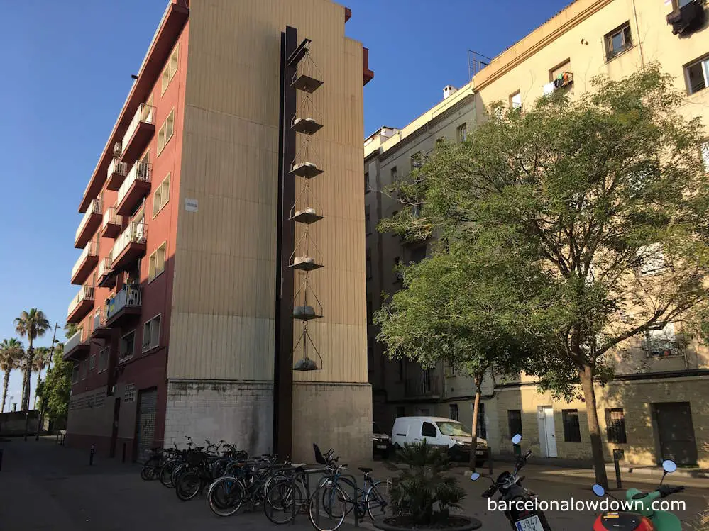 The Roman Scales sculpture on the side of a building in the Barceloneta neighbourhood of Barcelona