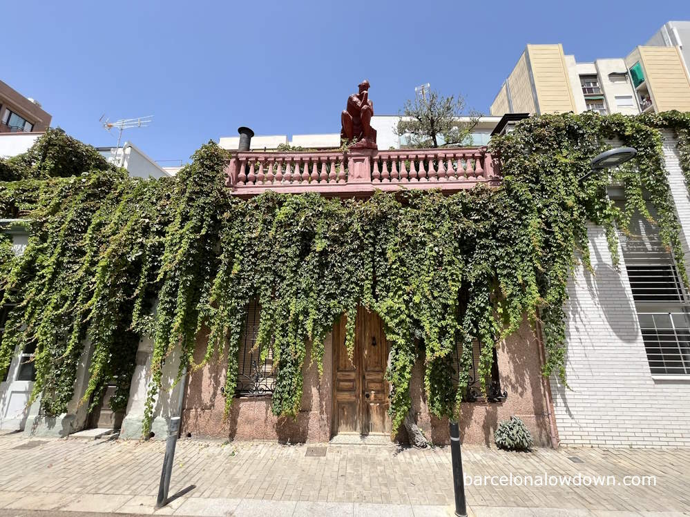 An old house in Barcelona with a replica of Rodin's The Thinker on the roof