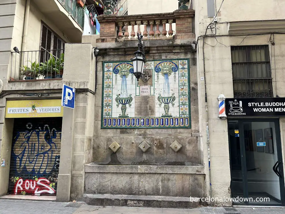 A traditional stone drinking fountain in Barcelona's Gràcia neighbourhood